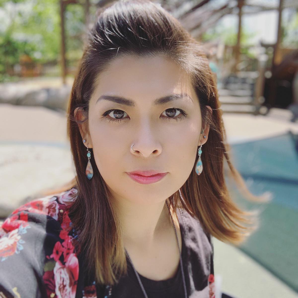 Ikumi outdoors, wearing a floral top